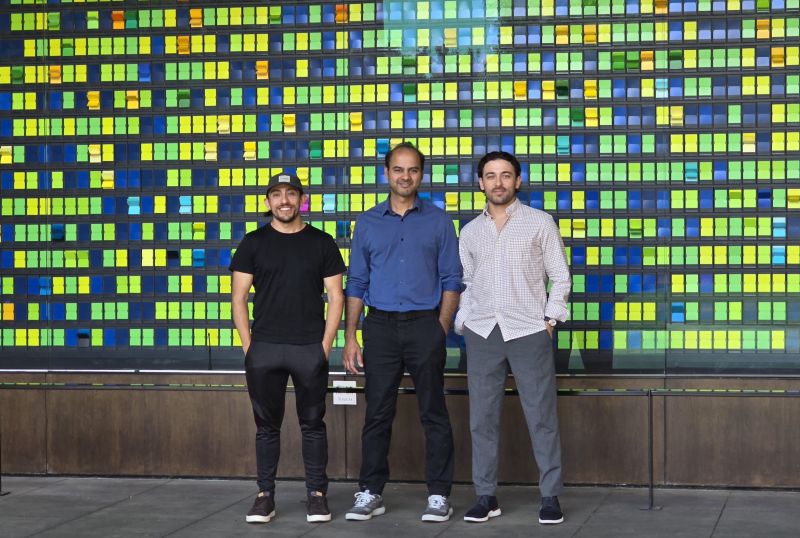 Rahul Chabukswar standing with two Homesome colleagues in front of a colorful tiled wall at Stanford