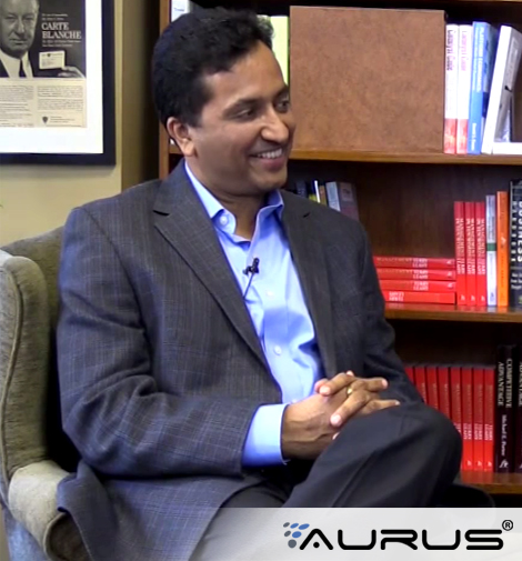 Rahul Mutha seated for a 2014 payments interview, wearing a grey jacket and blue shirt