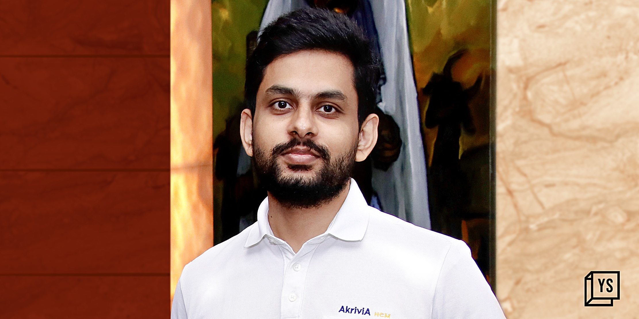 Rahul Varma Kalidindi wearing a white Akrivia HCM polo shirt in a press photograph