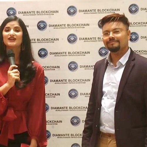 Raj Chowdhury standing beside an interviewer in front of a Diamante Blockchain event backdrop