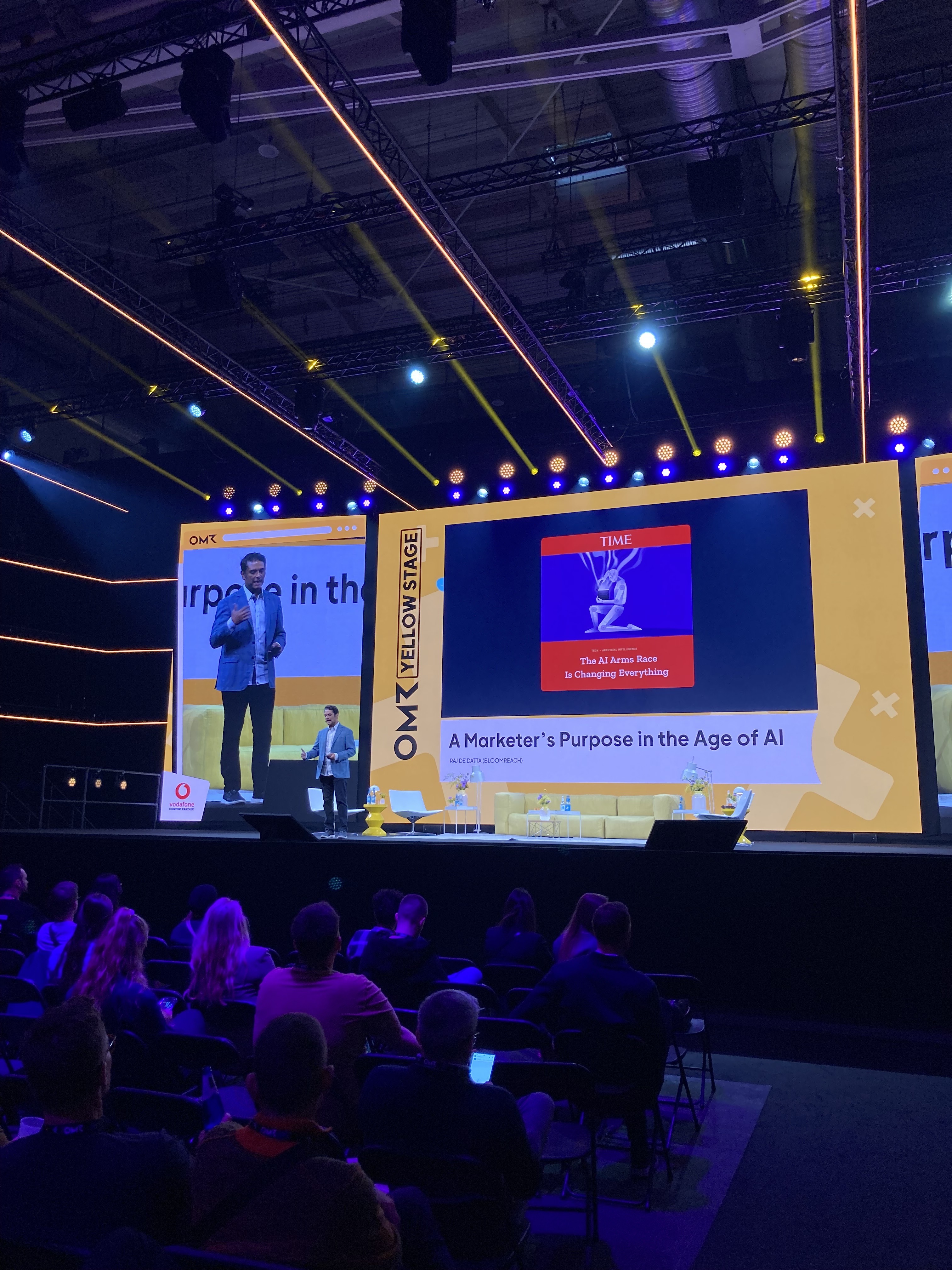 Raj De Datta speaking on the Yellow Stage at OMR, with a presentation about a marketer's purpose in the age of AI