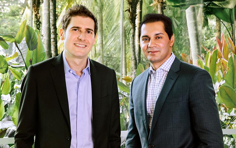 Eduardo Saverin on the left and Raj Ganguly on the right, standing together in Singapore