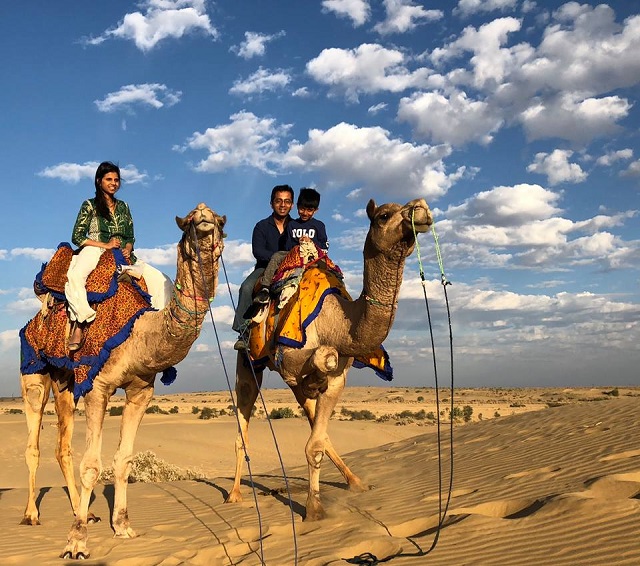 Deepti Juturu, Rajat Mishra and their son Sameer riding camels in Rajasthan