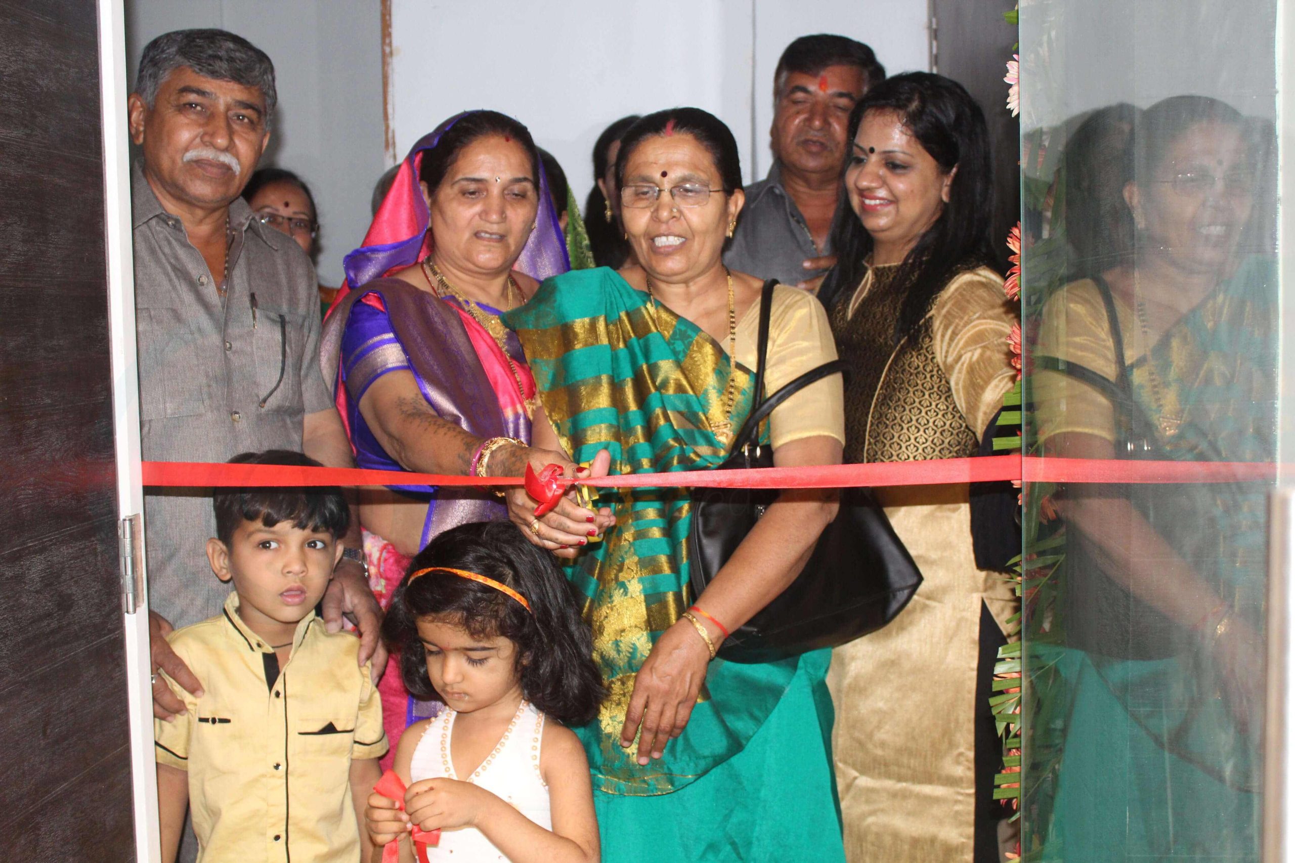 Family members cutting a red ribbon at the 9series office inauguration