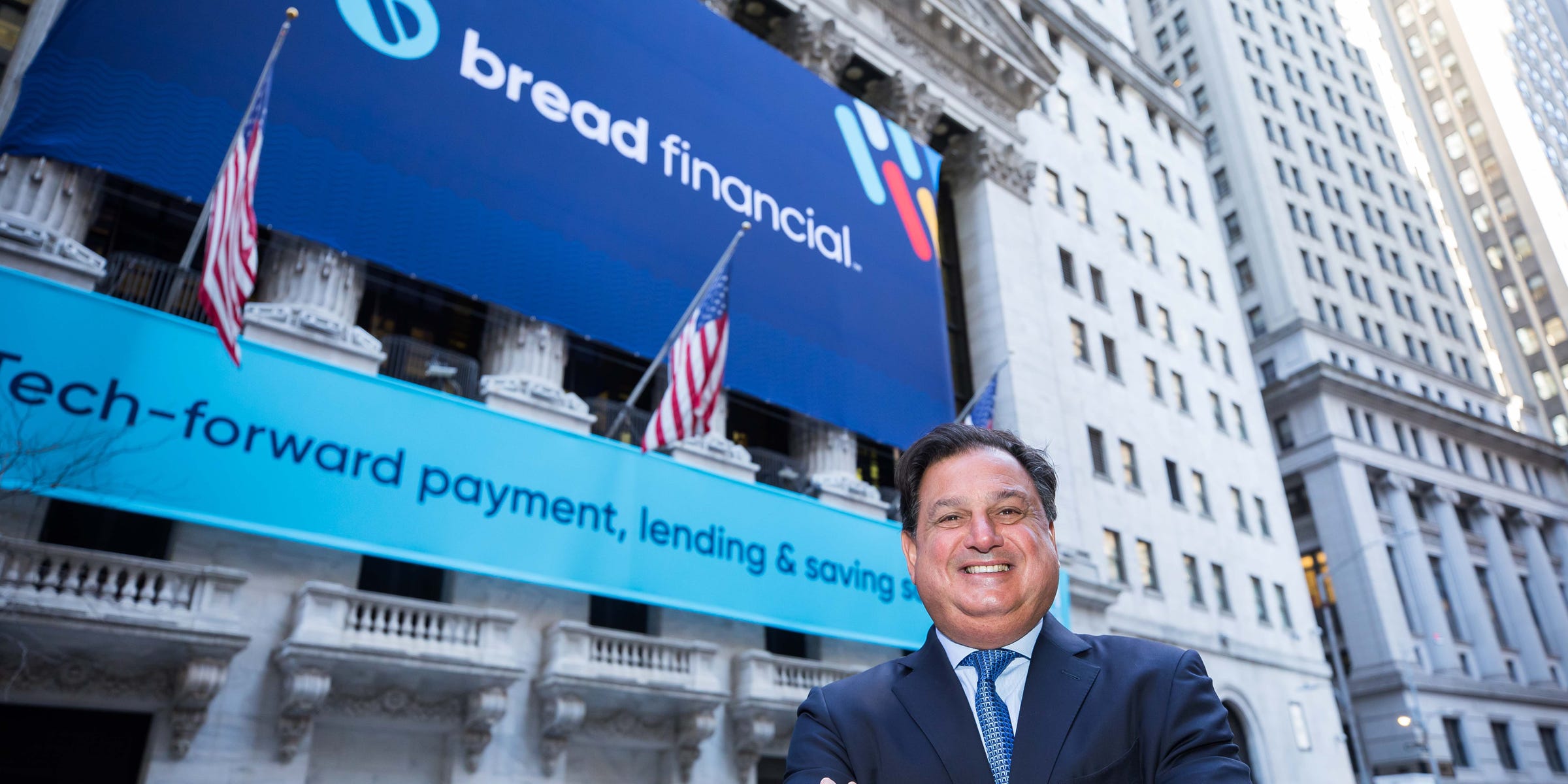 Ralph Andretta outside the New York Stock Exchange beneath Bread Financial banners