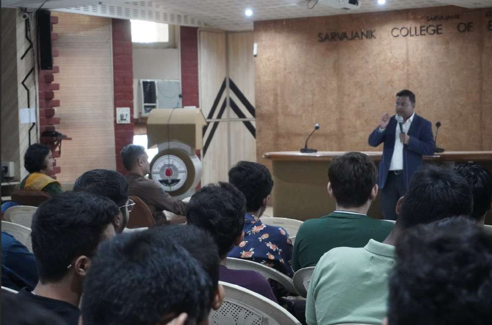 Students listening to Ramendra Shukla discuss generative AI in a college seminar hall
