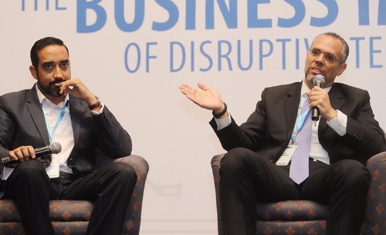 Ramzi Toubassy, right, speaking into a microphone beside Dipen Mehta at the What’s Next conference.