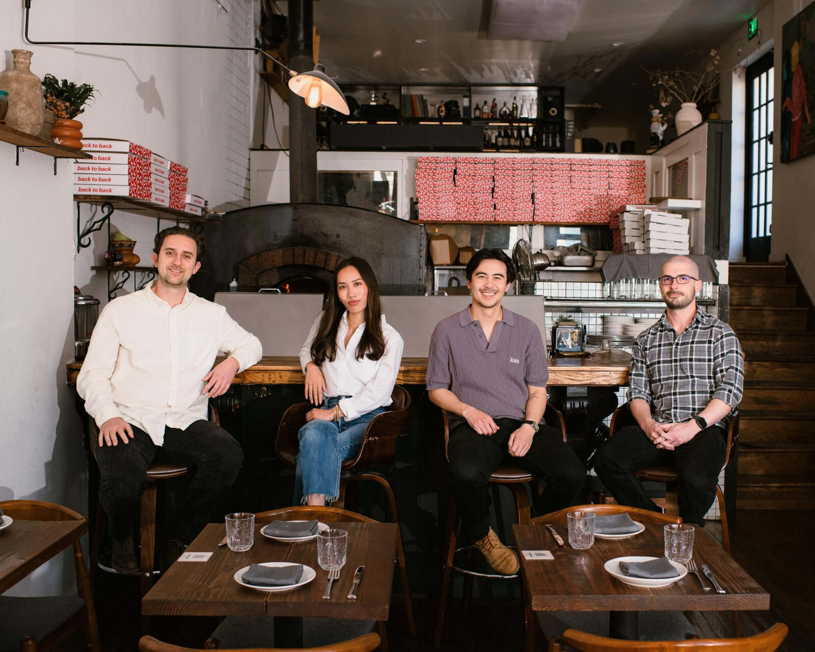 Randall Hom and colleagues seated at the counter inside Back to Back in San Francisco