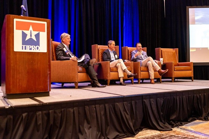 Three panel participants seated on the TIPRO summer conference stage in San Antonio