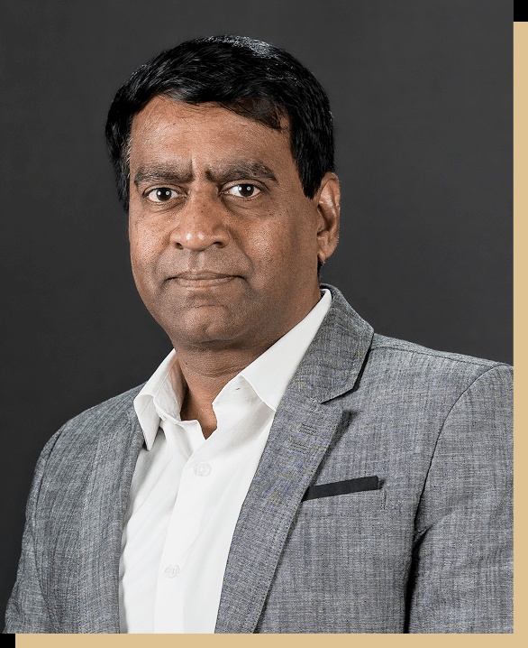 Praveen Kola, RandomTrees founder and CEO, wearing a gray jacket