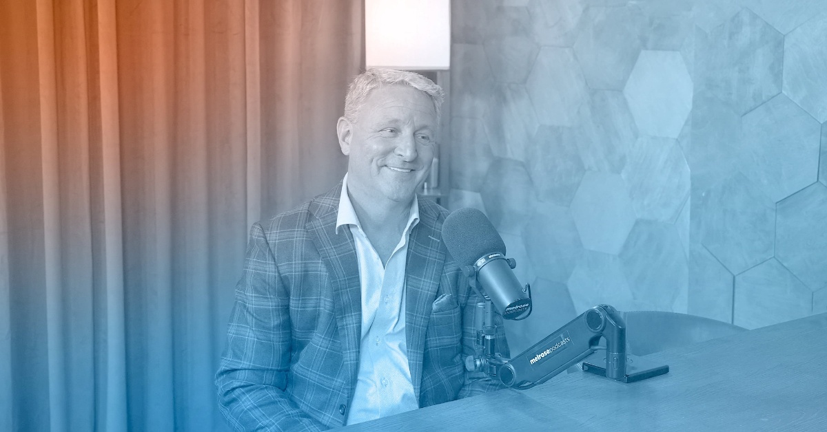 Randy Boldyga seated at a microphone during his Minding My Business conversation
