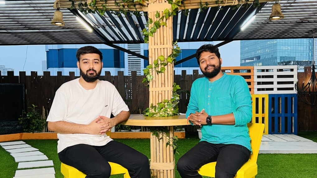 Ranveer Allahbadia and Viraj Sheth seated together on a rooftop