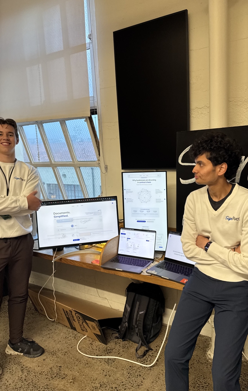Ranvir Deshmukh and Erik Peterson presenting SignPact beside several product screens