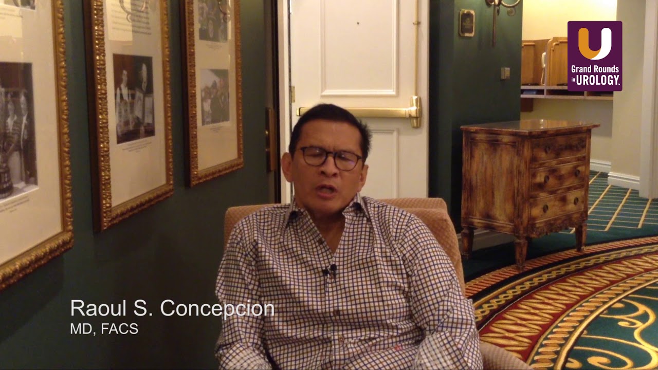 Raoul Concepcion seated for a recorded interview, wearing glasses and a checked shirt