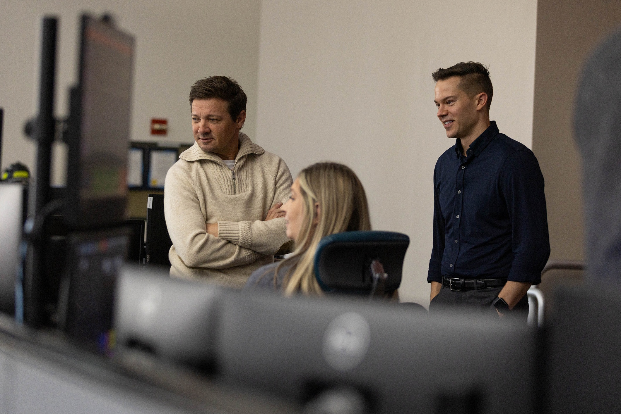 Jeremy Renner and RapidSOS CEO Michael Martin beside a dispatcher during a visit to emergency communications staff in Nevada