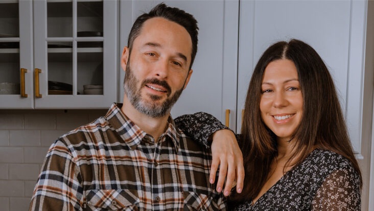 Jim and Tara Delmage of Sip and Feast standing together in a kitchen
