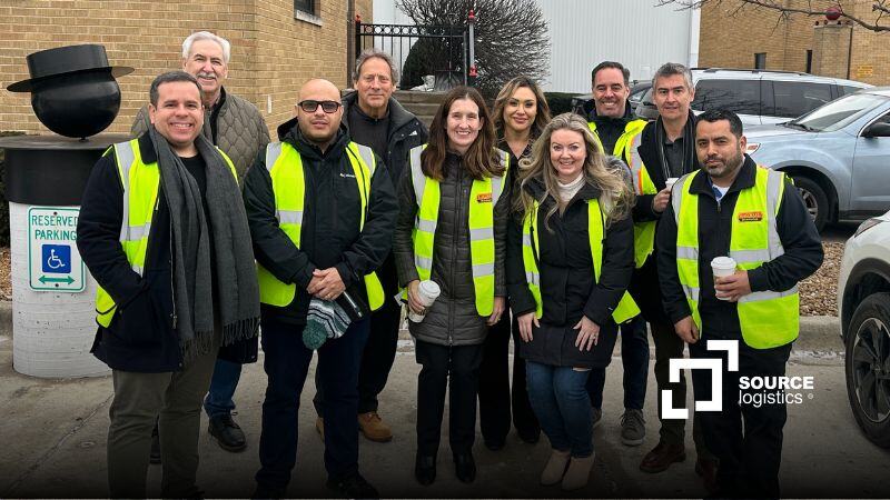 Source Logistics and LaGrou colleagues outside a warehouse, wearing high-visibility vests