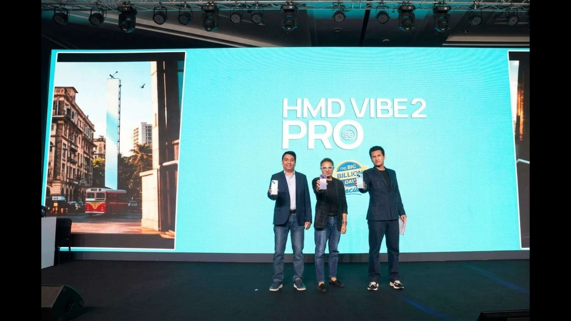 Ravi Kunwar, at left, holding a phone with two other participants on the HMD Vibe 2 Pro launch stage