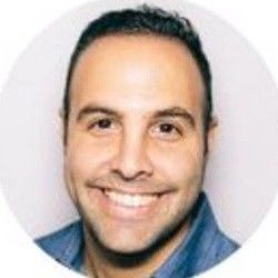 Ravid Razak smiling in a professional portrait