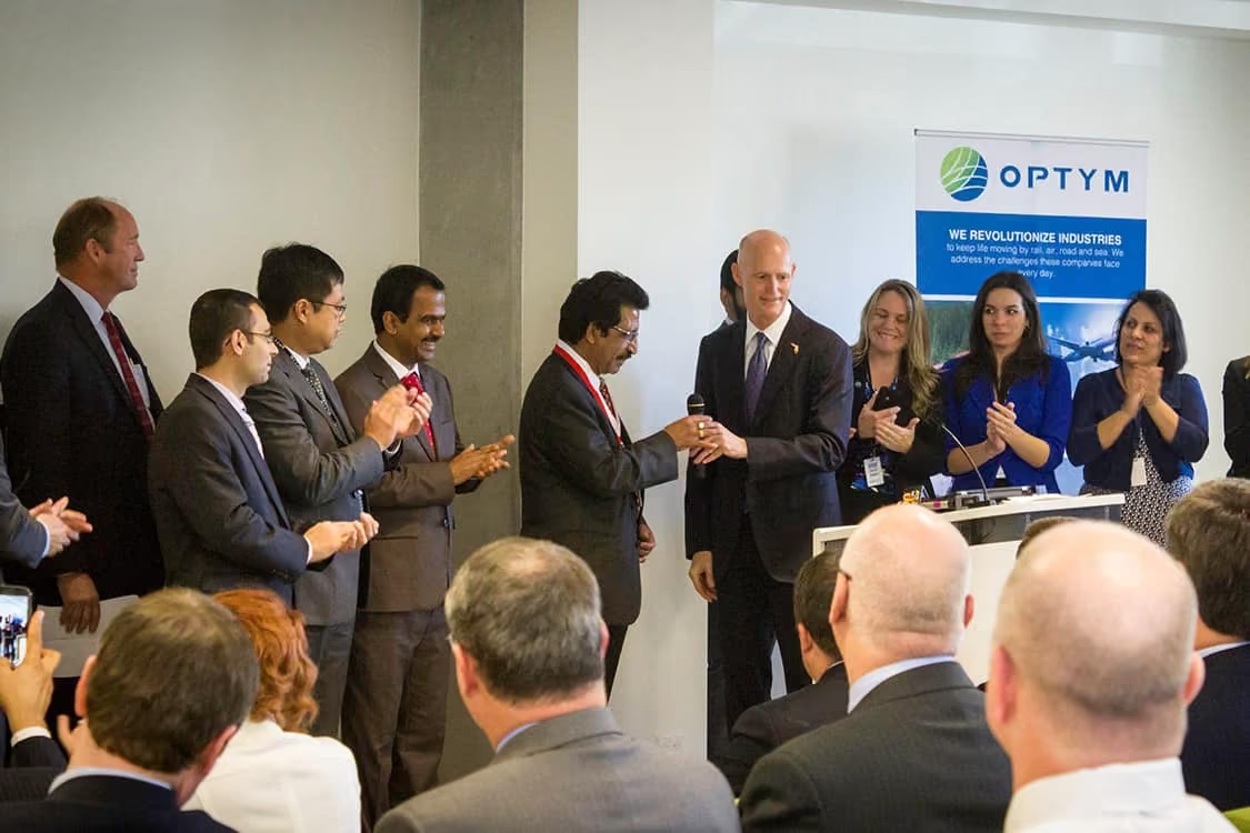 Ravi Ahuja with Florida Governor Rick Scott and attendees at Optym’s Gainesville headquarters opening