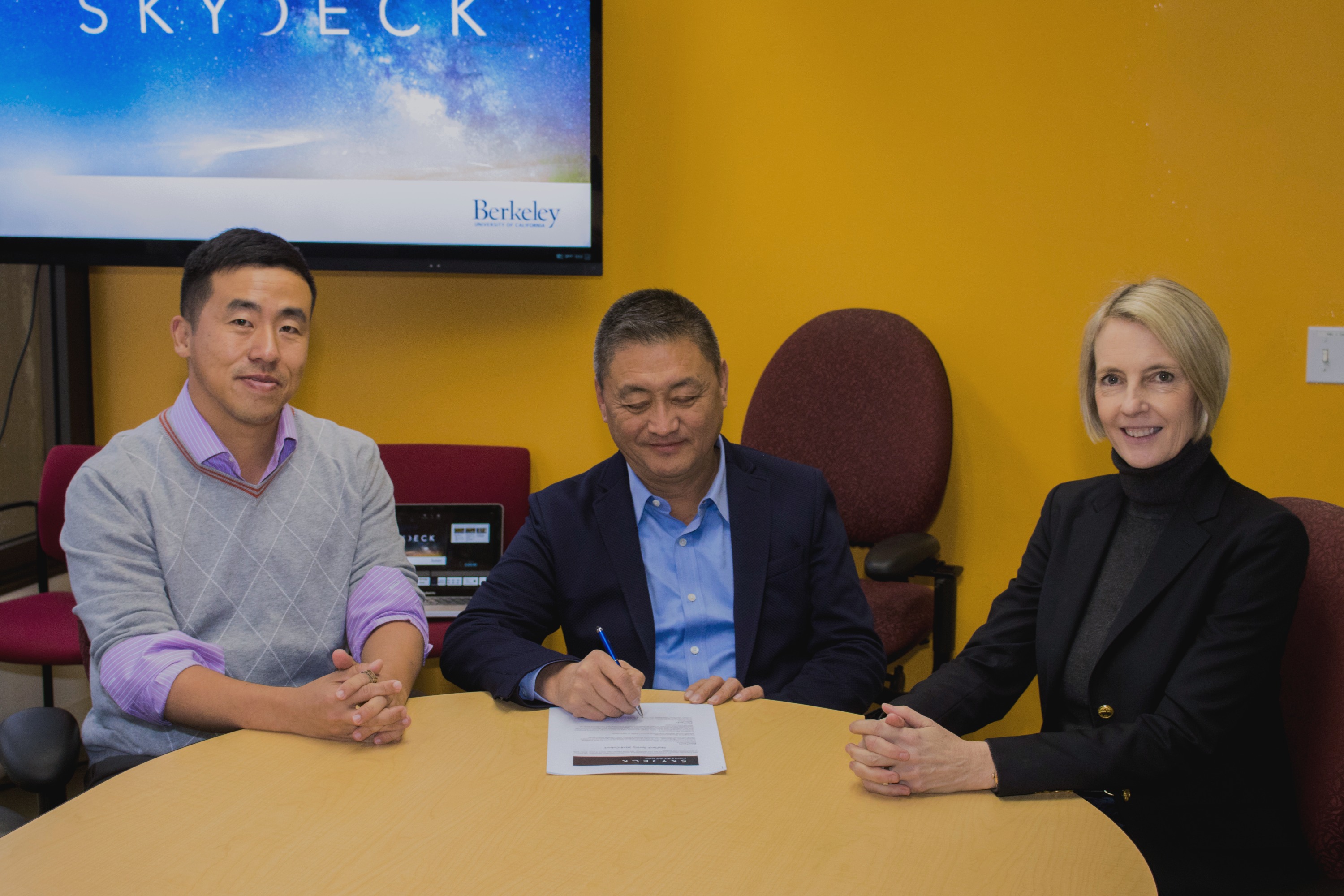 Chon Tang, Eric Sun and Caroline Winnett seated at the SkyDeck partnership signing