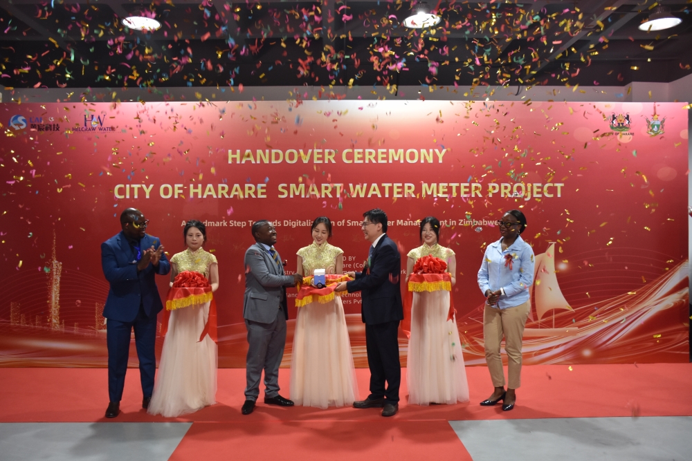 Raymond Zheng participates in the Harare smart water meter handover ceremony beneath falling confetti