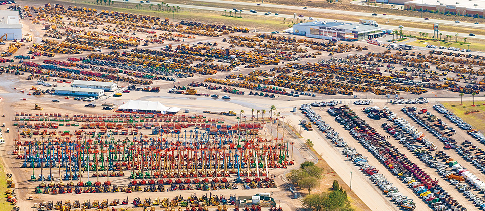 Archival aerial photograph of heavy equipment arranged in rows at the Ritchie Bros. Orlando auction yard