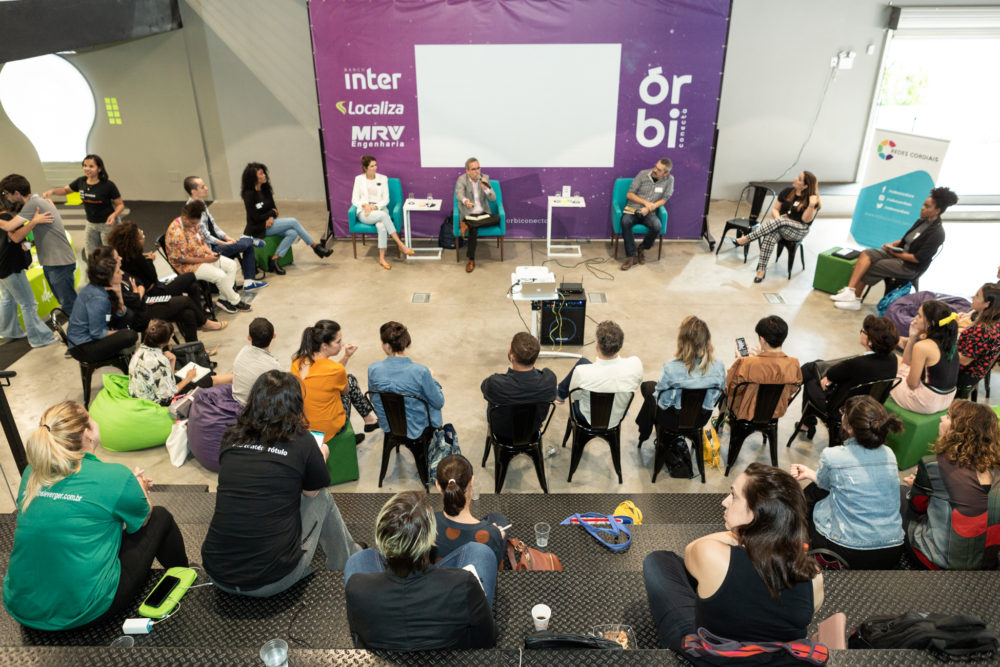Participants seated in a circle for a discussion at Órbi