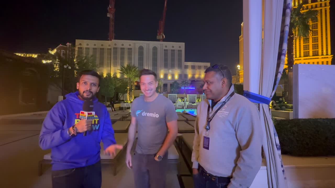 Read Maloney speaking with Ravit Jain and another attendee at an AWS re:Invent event