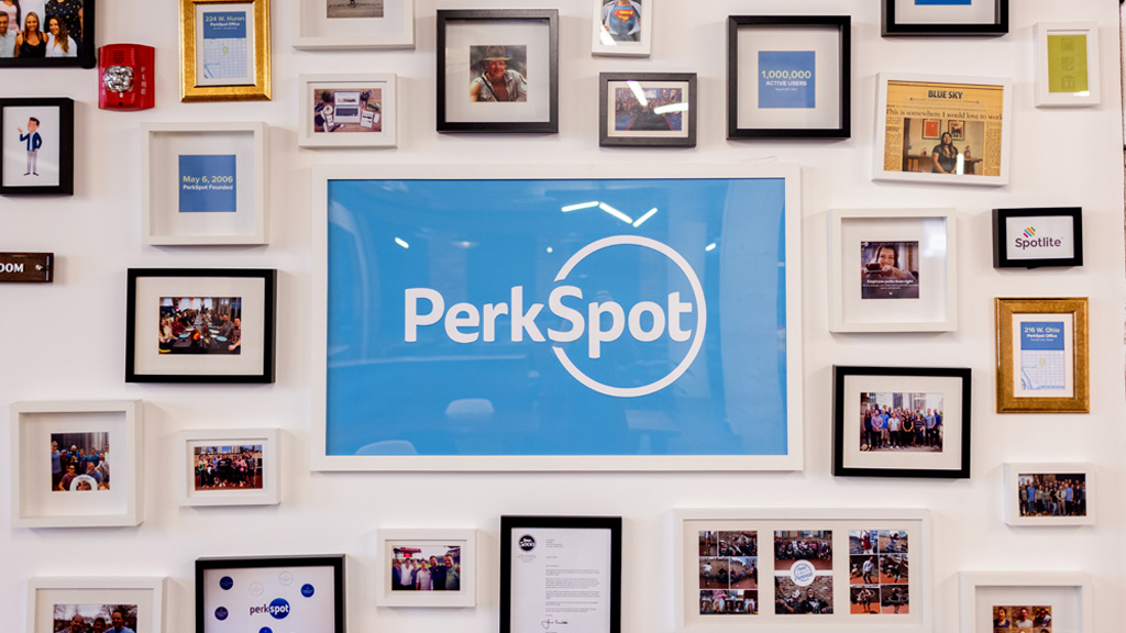 A gallery wall in PerkSpot's Chicago office, centered on the PerkSpot name