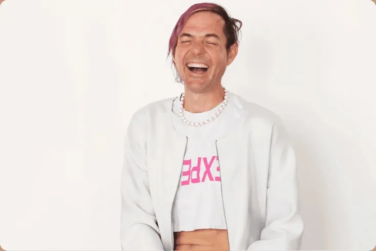 RebelMouse founder and CEO Andrea Berry laughing in a white jacket