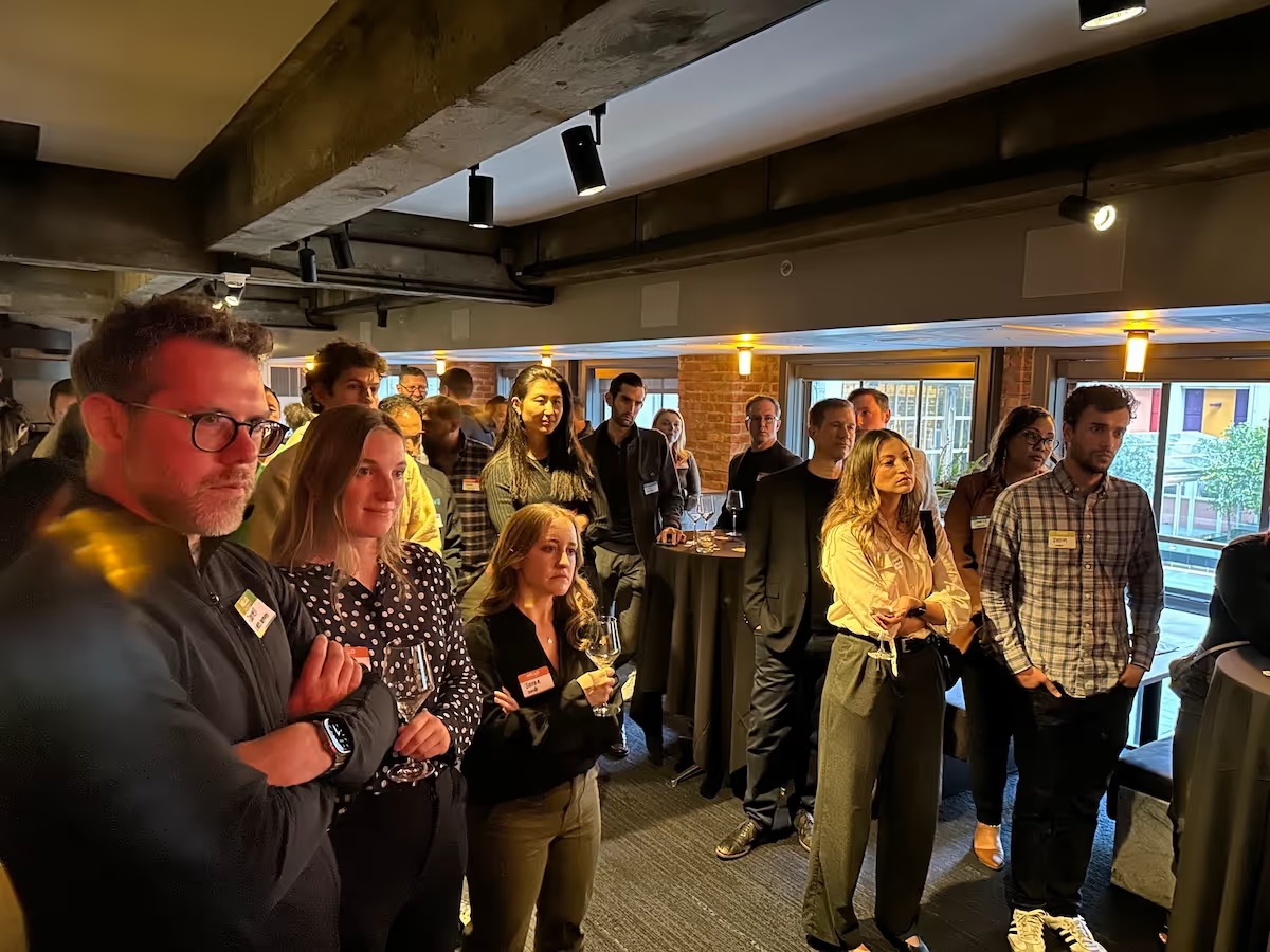 Attendees gathered at an event photographed on Recall Capital’s team page