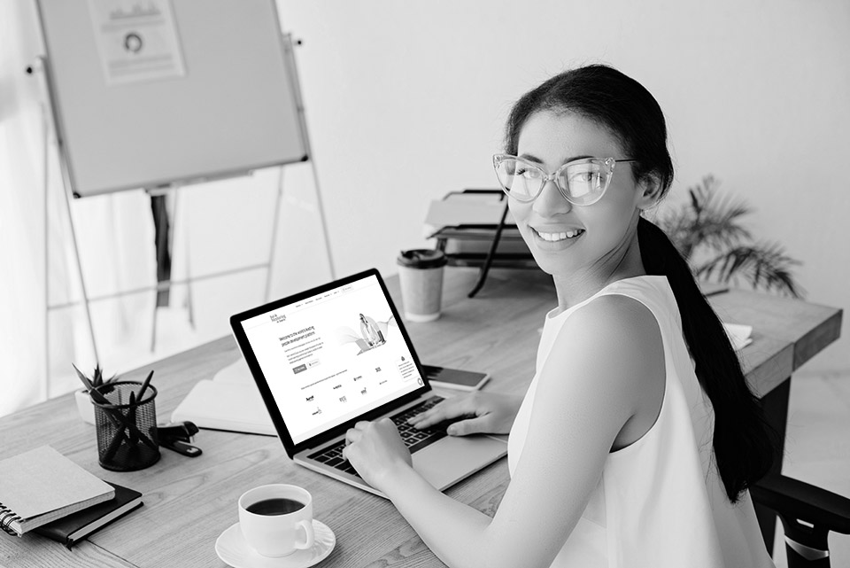 Company promotional illustration of a woman using a laptop displaying the mentoring website