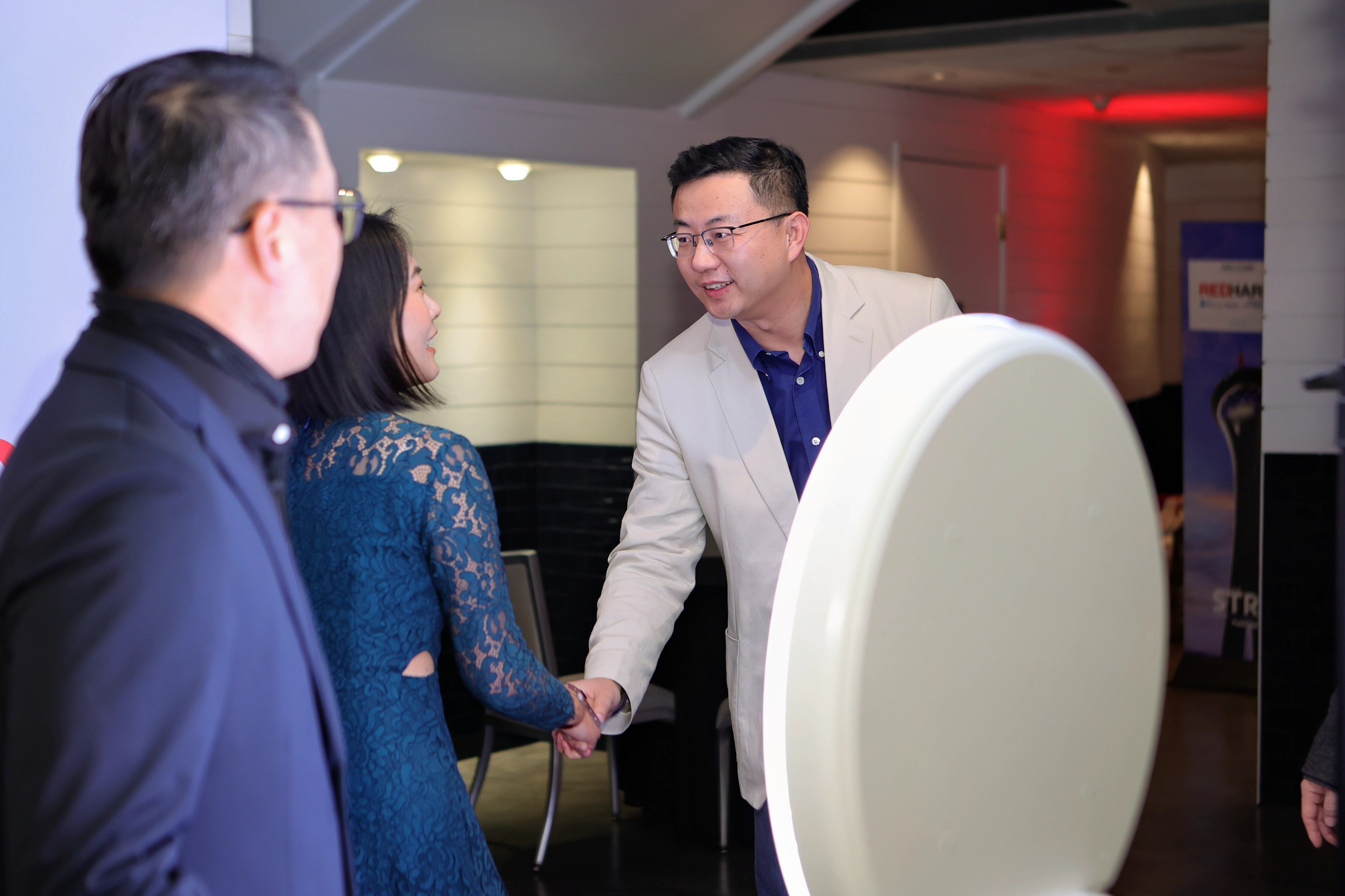 Guests greeting one another at an event shown in Red Harp’s portfolio
