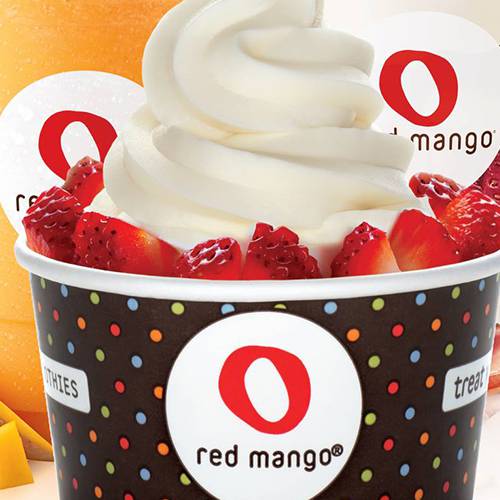 Red Mango frozen yogurt topped with strawberries in a branded cup