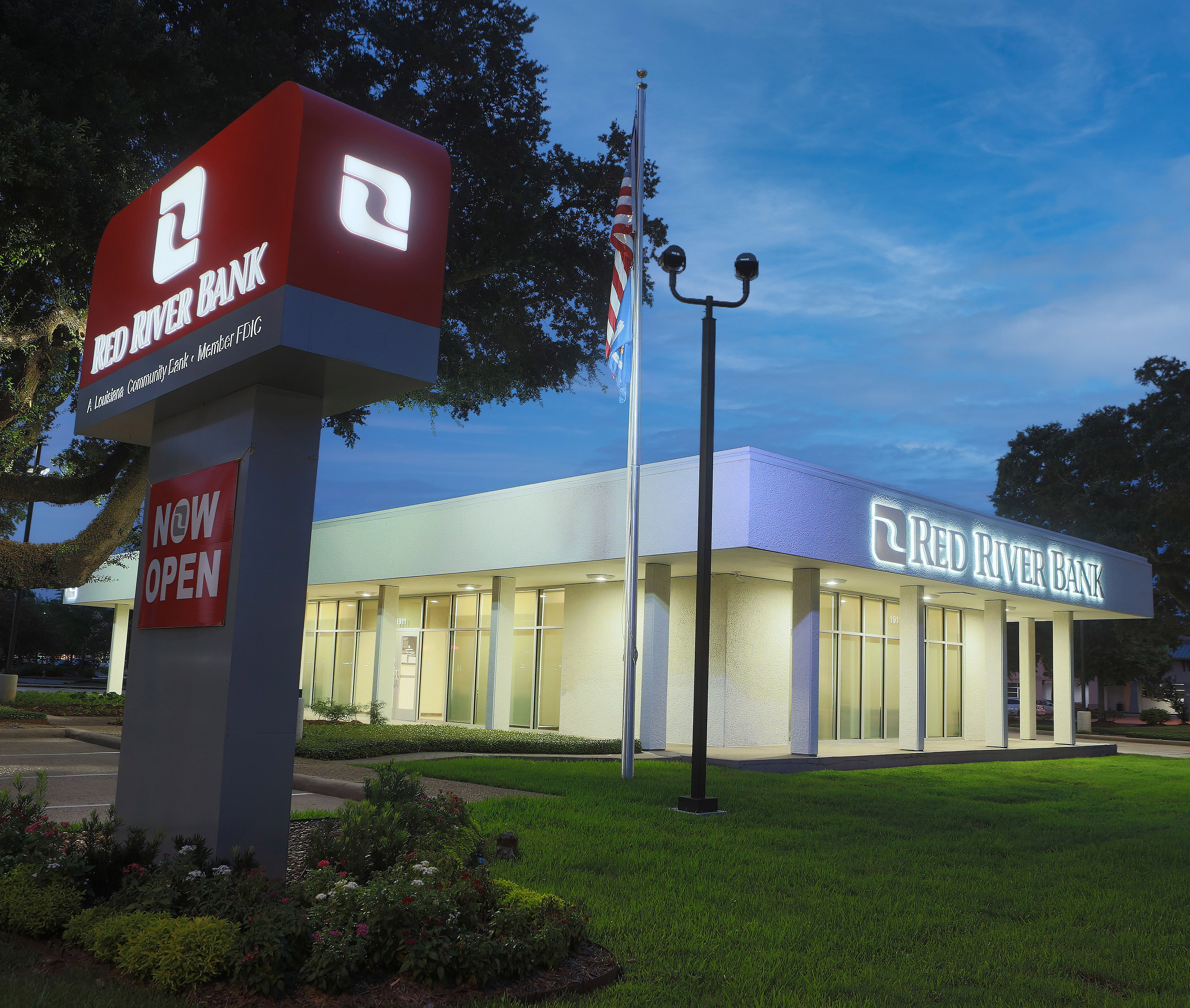 Red River Bank’s Lafayette banking center illuminated at dusk