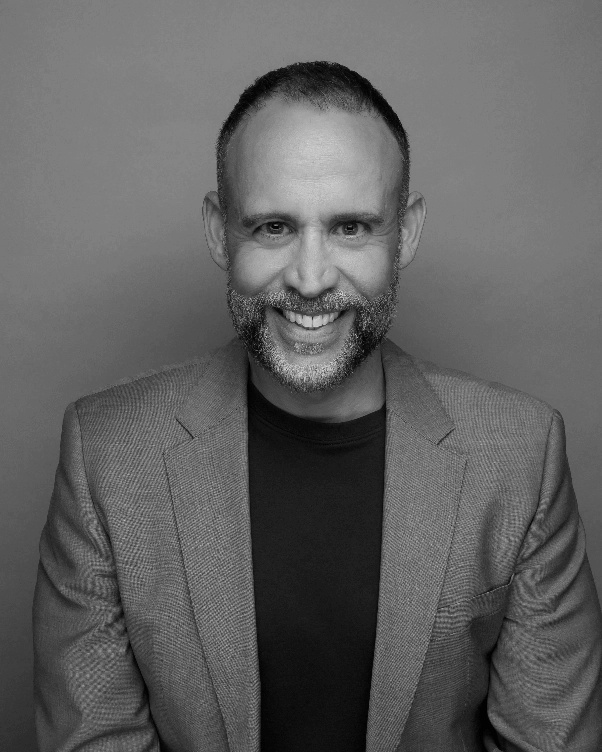 Official black-and-white portrait of Derek Dubner, red violet chairman and CEO