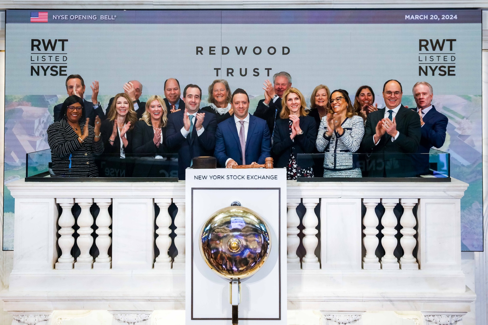 Redwood Trust team applauding at the New York Stock Exchange opening bell ceremony
