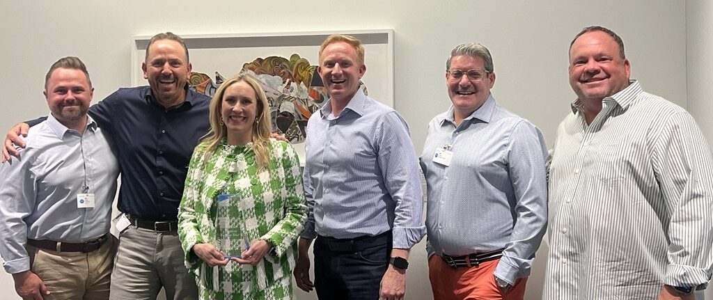 Profisee executives with Microsoft executive Jessica Hawk at a 2024 partner award presentation on the Microsoft campus