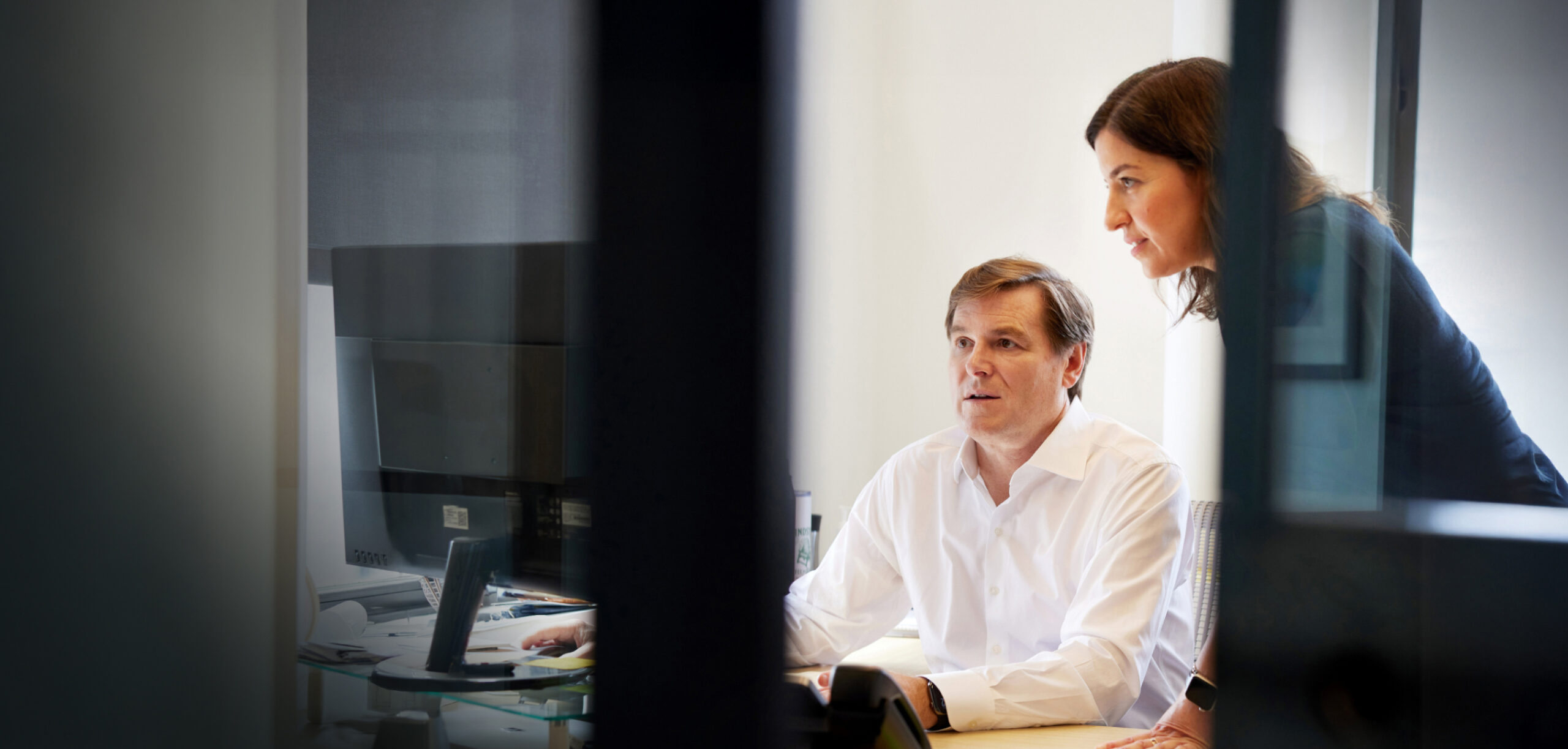 Reevemark colleagues collaborating around a table