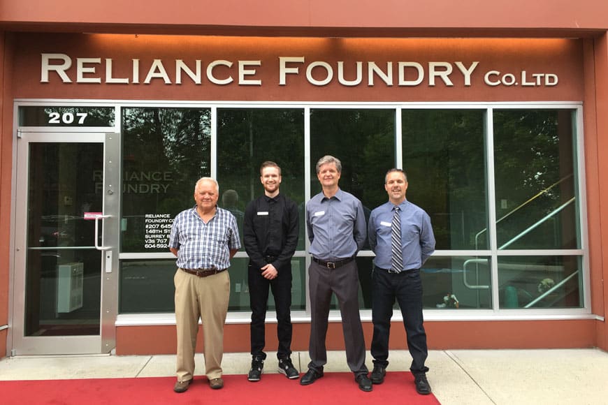 Three generations of the Done family in front of a Reliance Foundry building