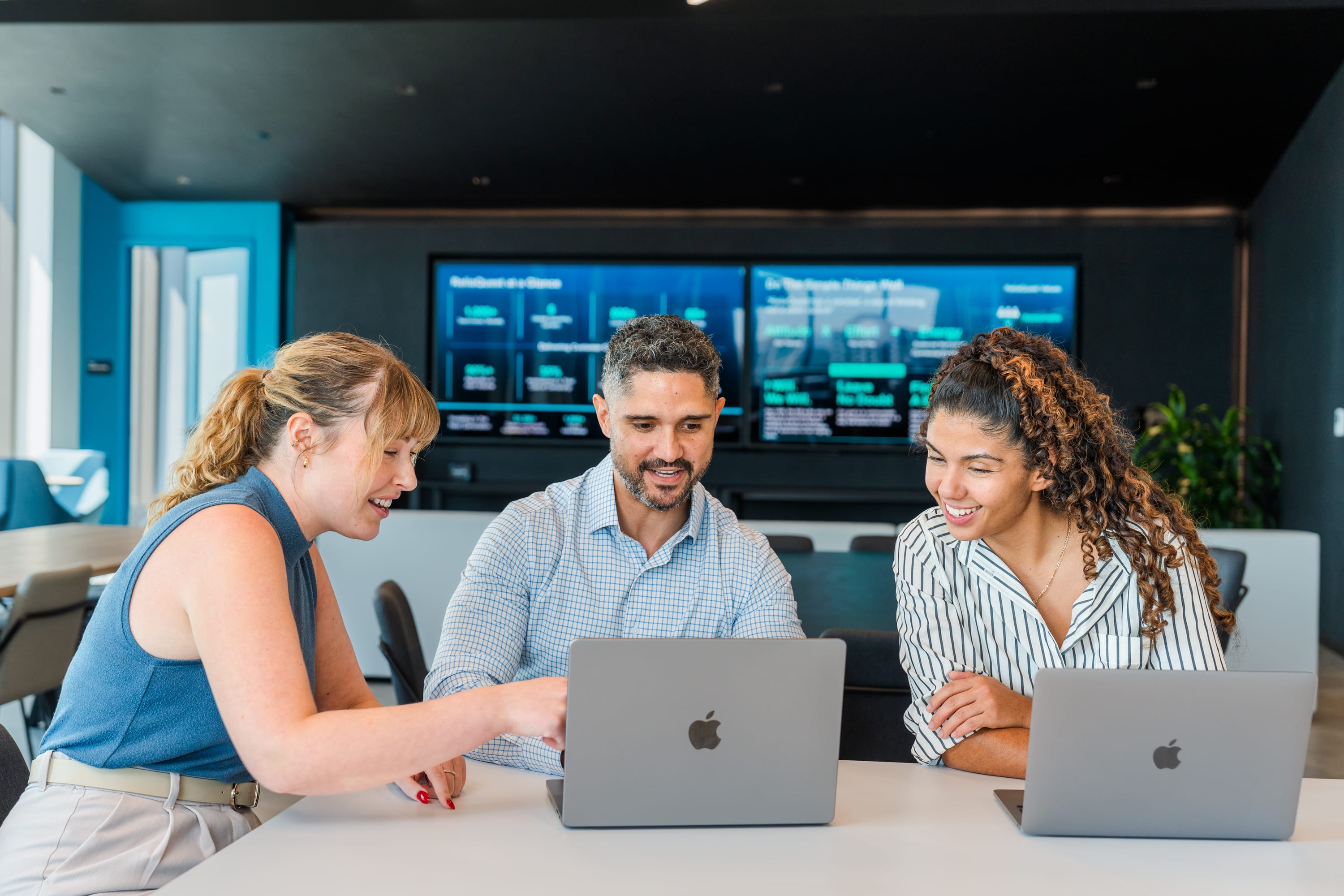 ReliaQuest employees collaborating in an office