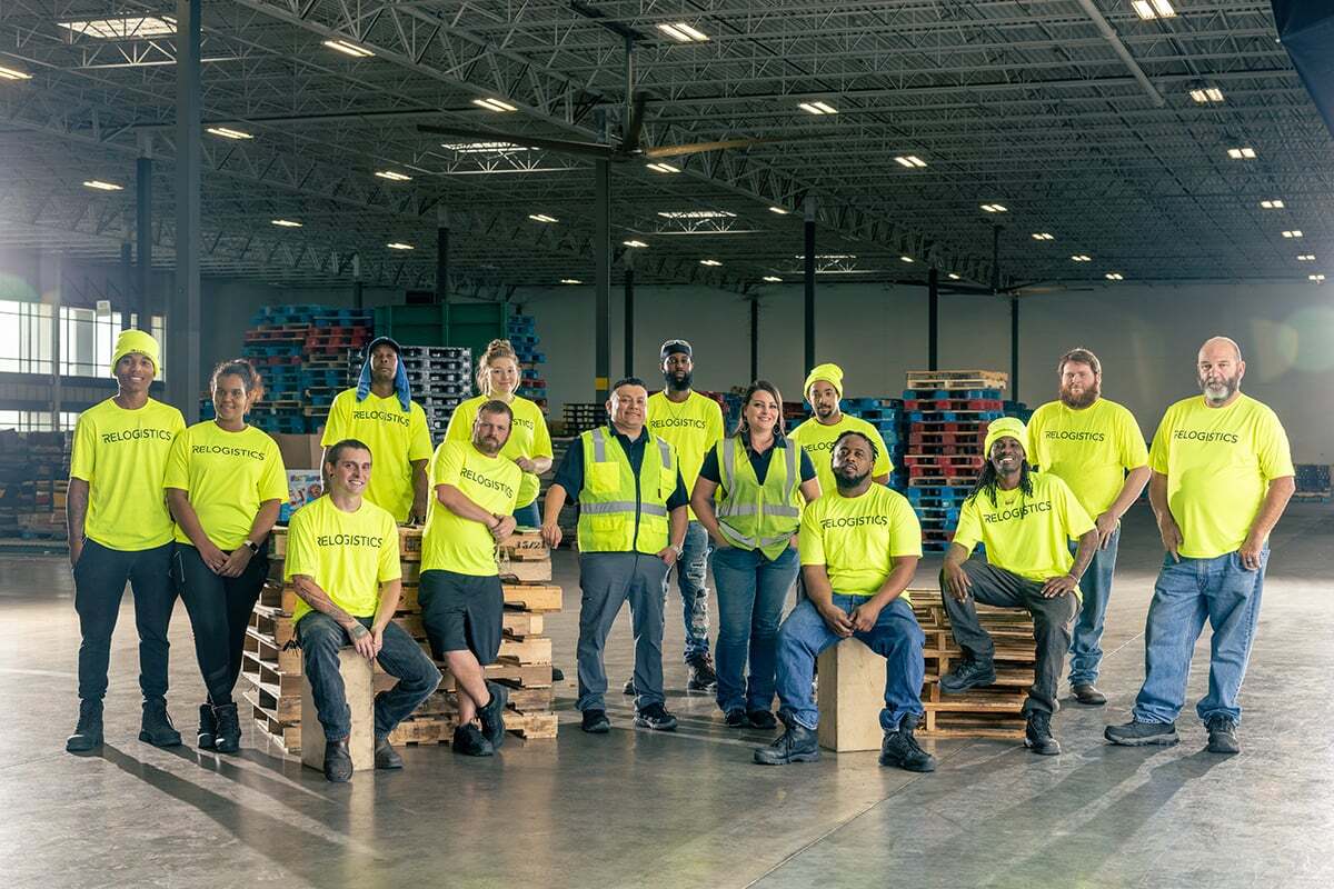Relogistics warehouse team wearing bright safety shirts and vests