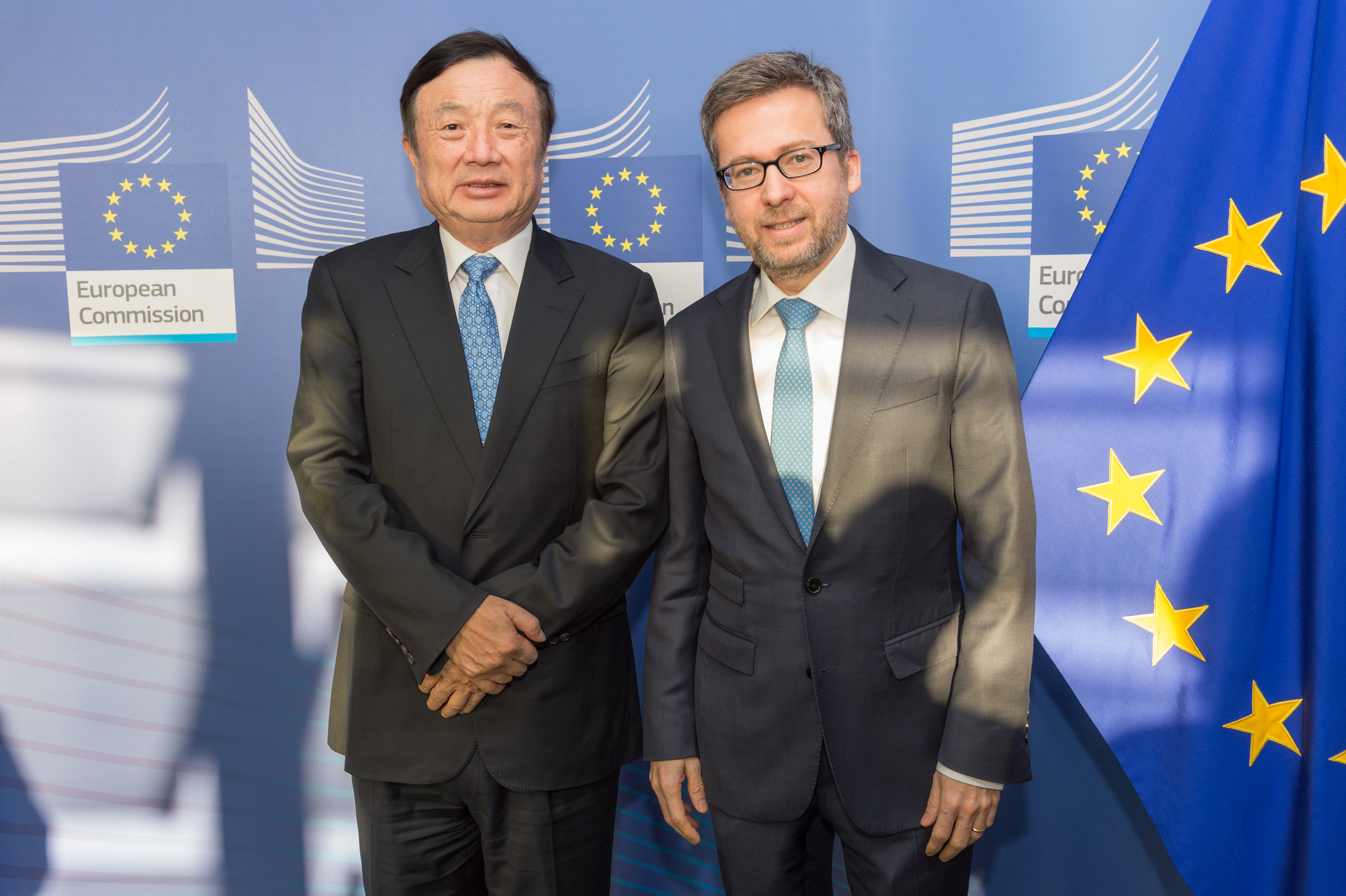 Ren Zhengfei, left, standing beside European Commissioner Carlos Moedas in Brussels in 2016