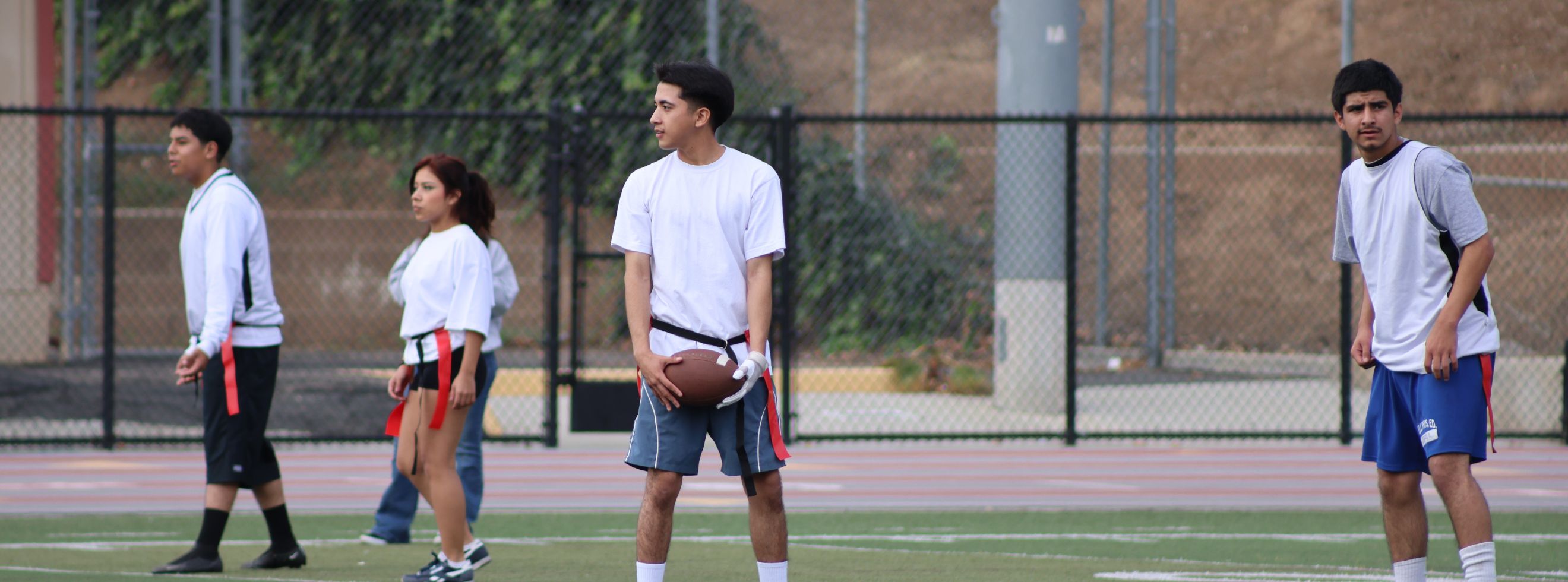 Renaissance High School students playing flag football on an outdoor field