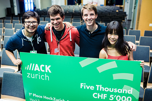 Rene Brandel, Julian Brendl, Michael Vakoč, and Yue Ou holding the HackZurich first-place board in 2016