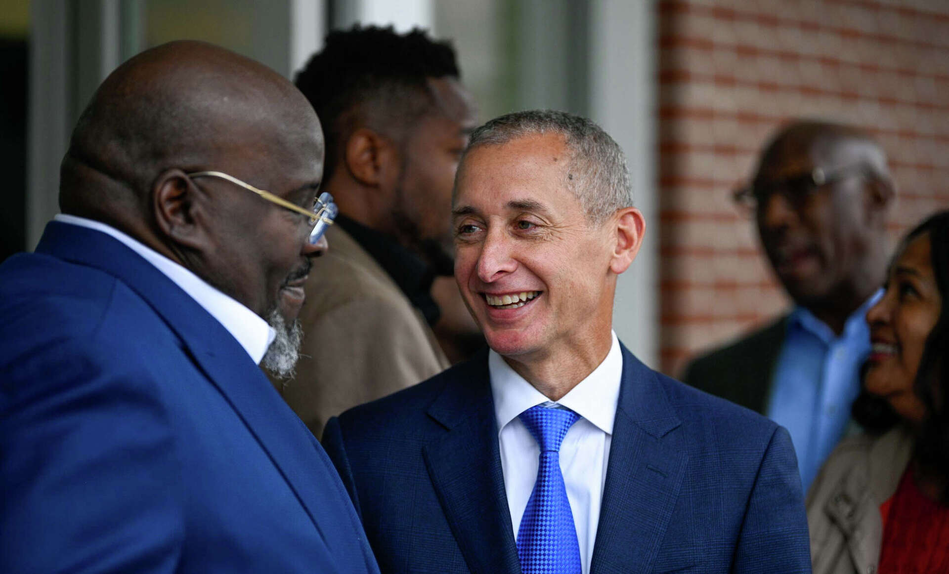 René Jones, right, speaking with Dwayne Smith at the Honey Locust Square branch opening in Bridgeport.