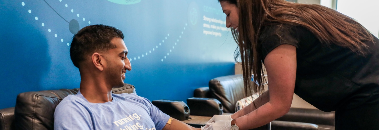 A Restore nurse assisting a client during an IV therapy session