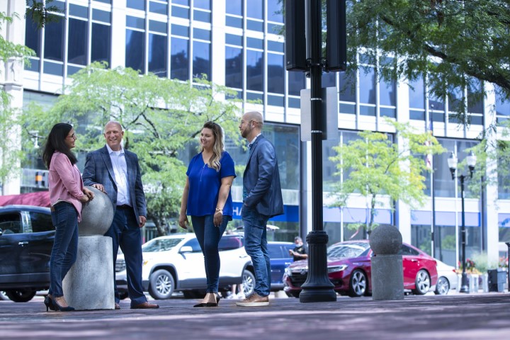 Four Resultant colleagues talking outdoors in downtown Indianapolis