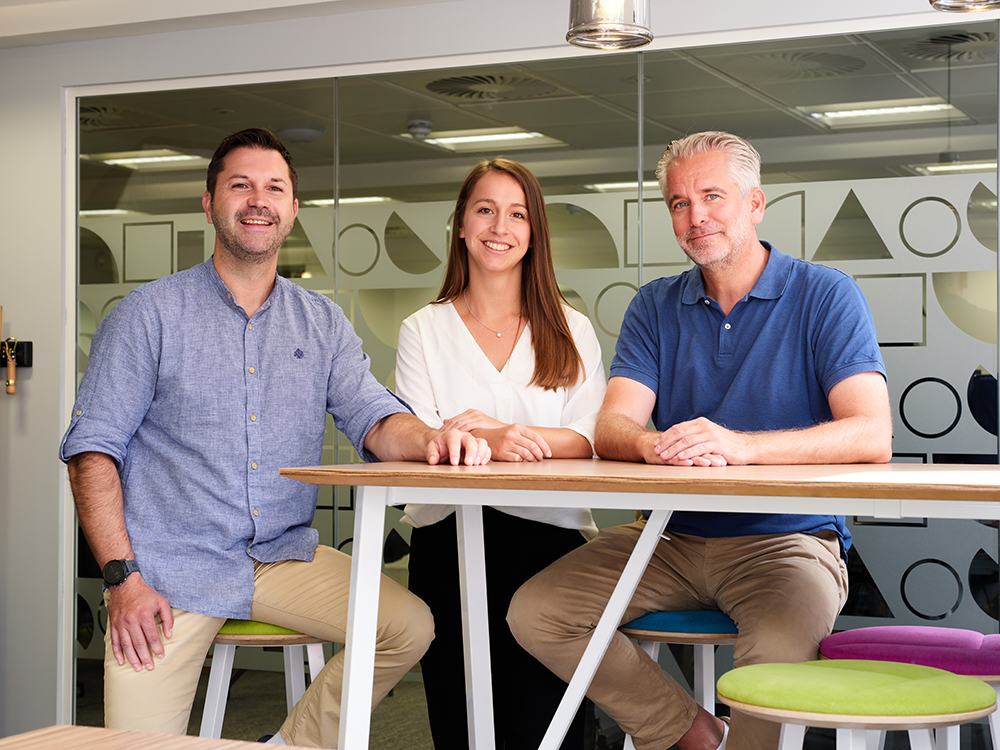 Three Retail Insight leaders in the DACH region standing together in a modern office